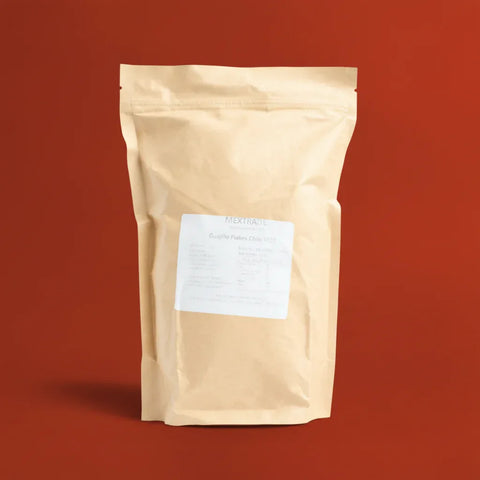 Beige bag of Guajillo Flakes on a red background