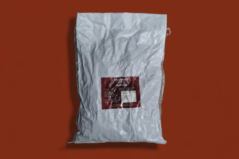White bag of Morita chili on a burnt orange background.