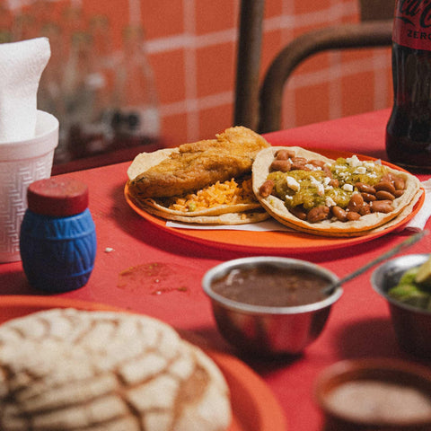 Corn tortillas with fish, rice, pinto beans, and salsa verde