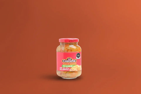 Jar of La Costeña sliced habanero peppers on a dark orange background