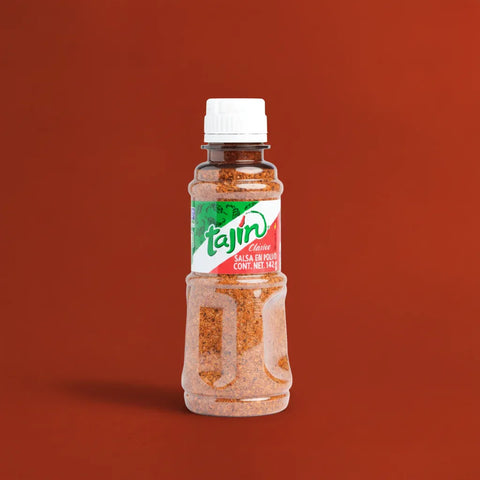 Bottle of Tajin seasoning on a brown background