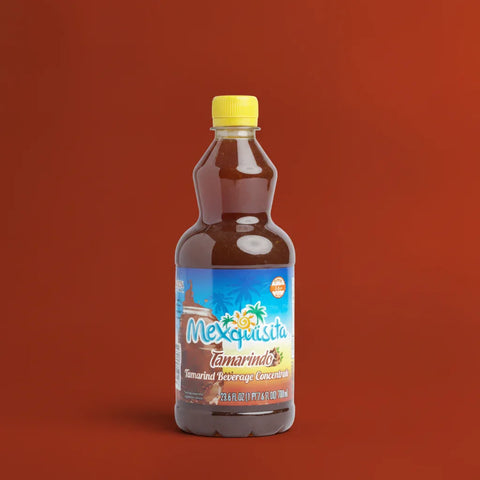 Bottle of Mexquisita Tamarind beverage concentrate on a red background