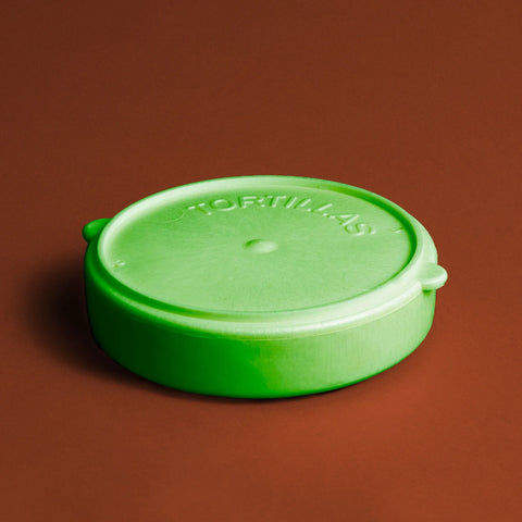 green tortilla warmer on a red background