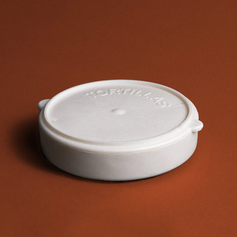 white plastic tortilla warmer on burnt orange background