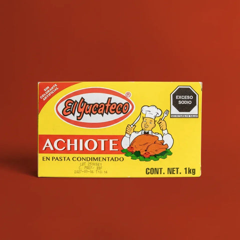 Yellow rectangle cardboard carton of El Yucateco Achiote paste on a red background