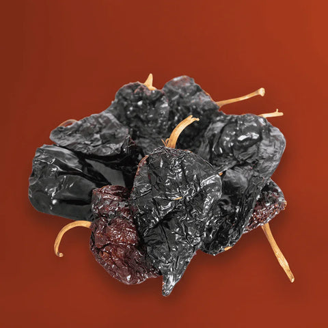 Dried ancho chiles on a brown background