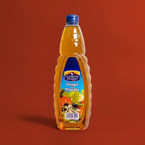 Bottle of apple vinegar made by Clemente Jacques on a red background