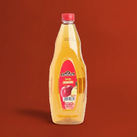 Bottle of La Costena apple cider vinegar on a red background