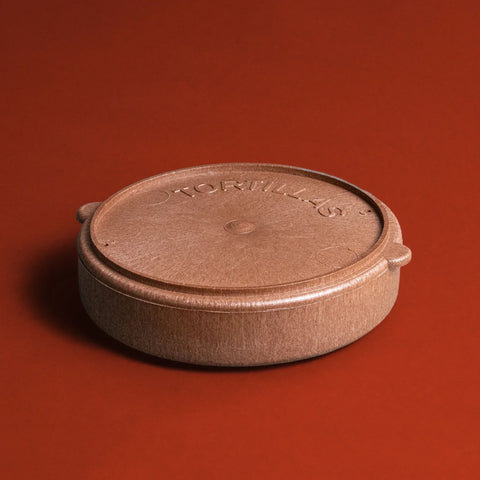 Brown plastic tortilla warmer with lid on a red background