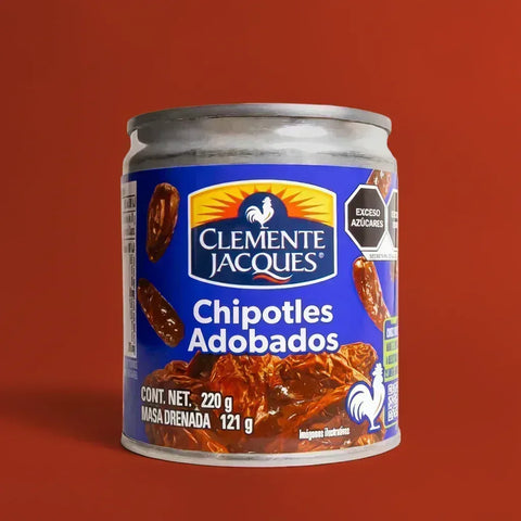 A Small can of Clemente Jacques Chipotle Peppers on a red background