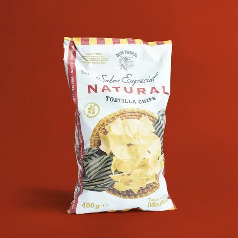 Bag of Nuevo Progreso Natural Tortilla Chips on a red background