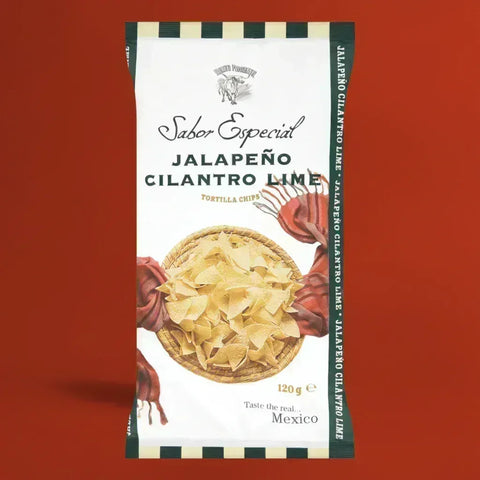 Bag of Nuevo Progreso Jalapeño Cilantro Lime tortilla chips on a red background