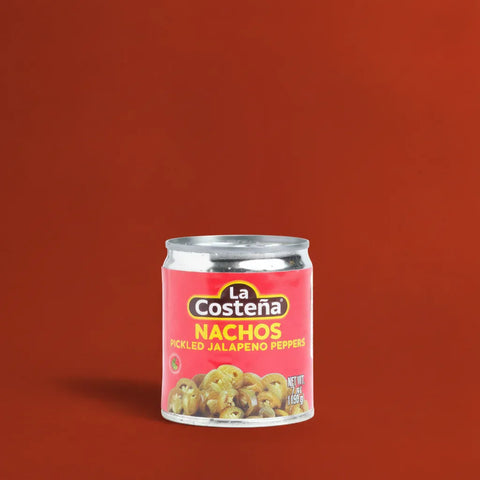 Can of La Costéna Nachos Pickled Jalapeno Peppers on a red background