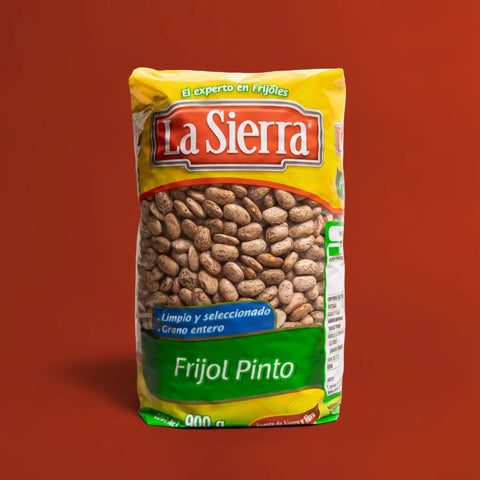Bag of La Sierra Pinto beans on a red background