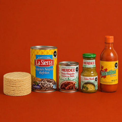 Tin of Refried Black Beans, Corn Tortillas, Chipotle Peppers, Green Salsa and Hot Sauce on burnt orange background.