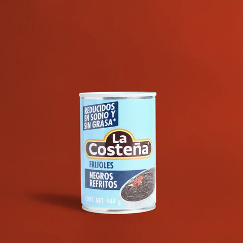 Can of La Costena black beans on a red background