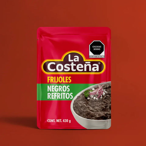 A Pouch of La Costena Refried Black Beans on a red background
