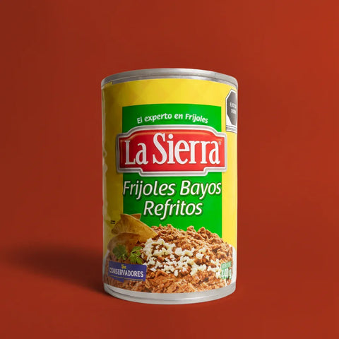 Can of La Sierra Frijoles Bayos Refritos on a red background