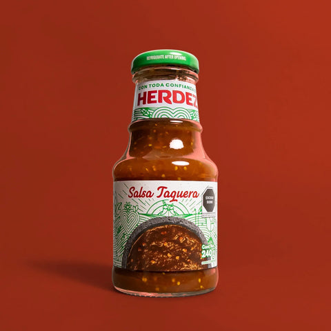 Herdez Salsa Taquera bottle on a red background