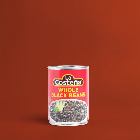 Can of La Costena whole black beans on a brown background