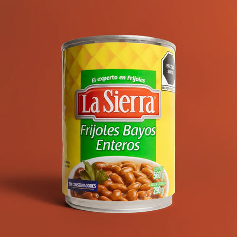 Can of La Sierra Frijoles Bayos Enteros on a red background