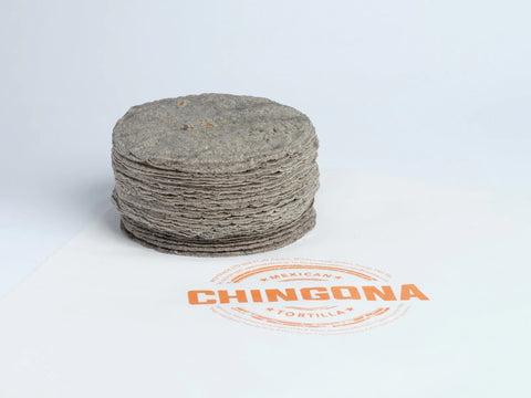Stack of tortillas with 'Chingona' branding on a light gray background