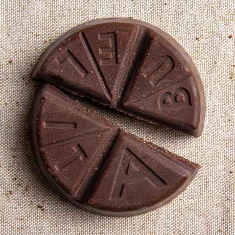 Chocolate bars with 'ABULEITA' branding on a textured surface